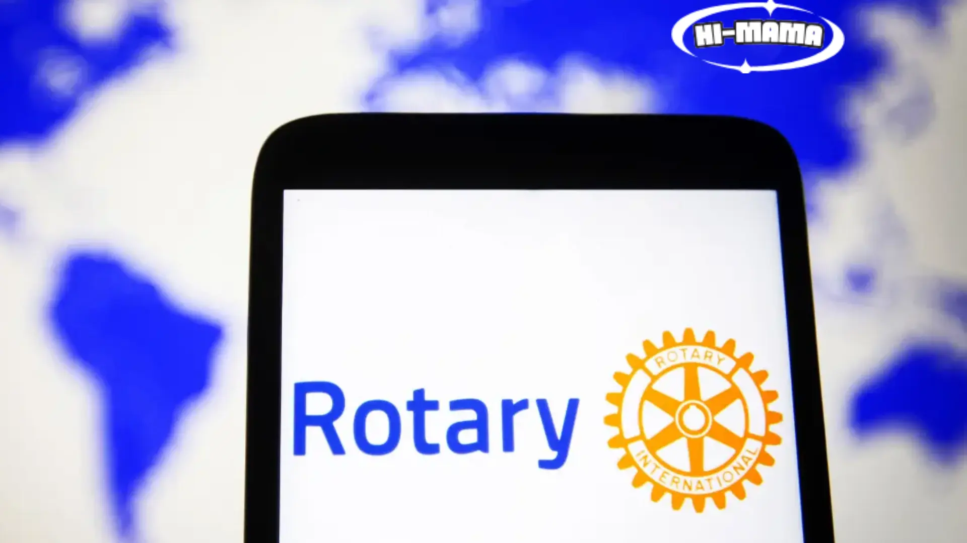 Rotary Club logo displayed on a smartphone screen, with a blurred world map in the background, representing global community service.