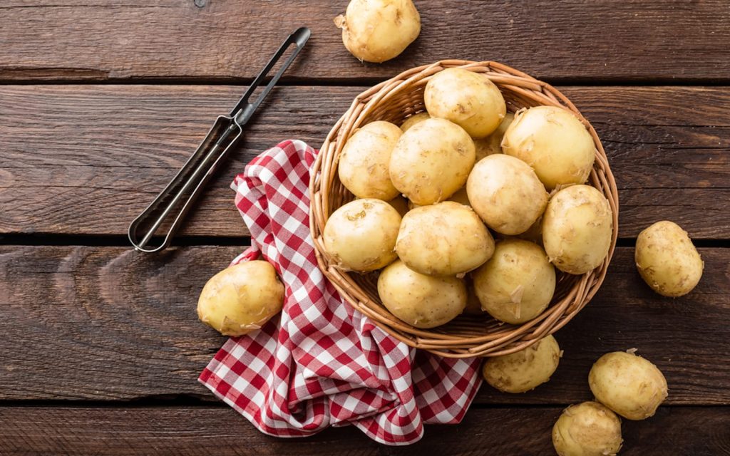 Potatoes in a Wood Bucket place on a wood table